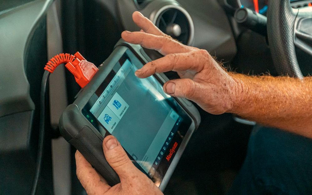 OBD diagnostic scanner in hand